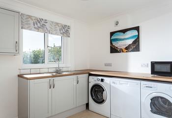 The utility room has handy appliances including a washing machine, tumble dryer and dishwasher.