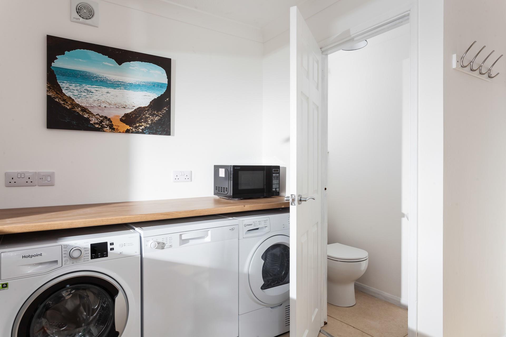 There is a cloakroom with an extra WC and basin.