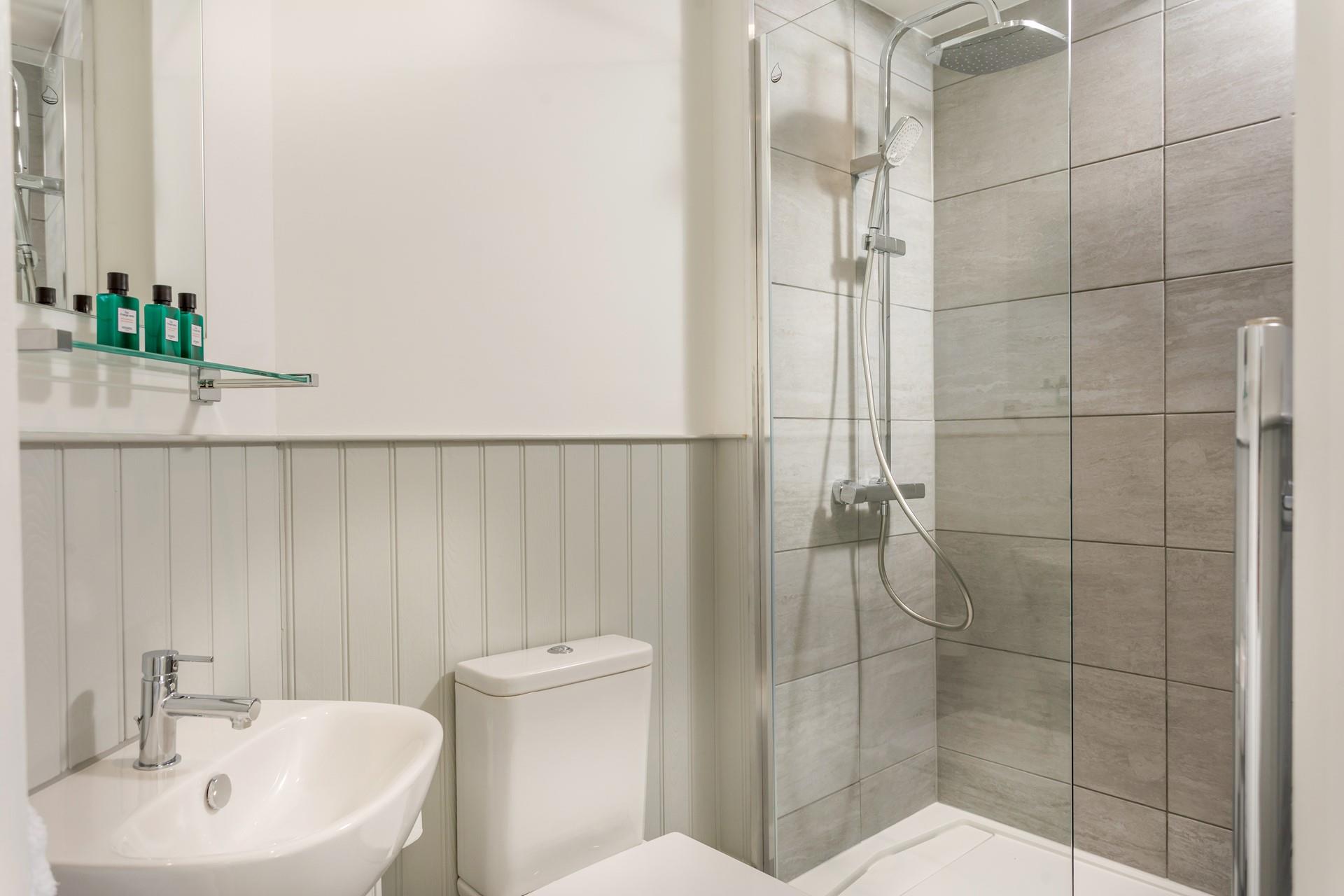 Wash off the sand from a beach day in the modern sleek bathroom.