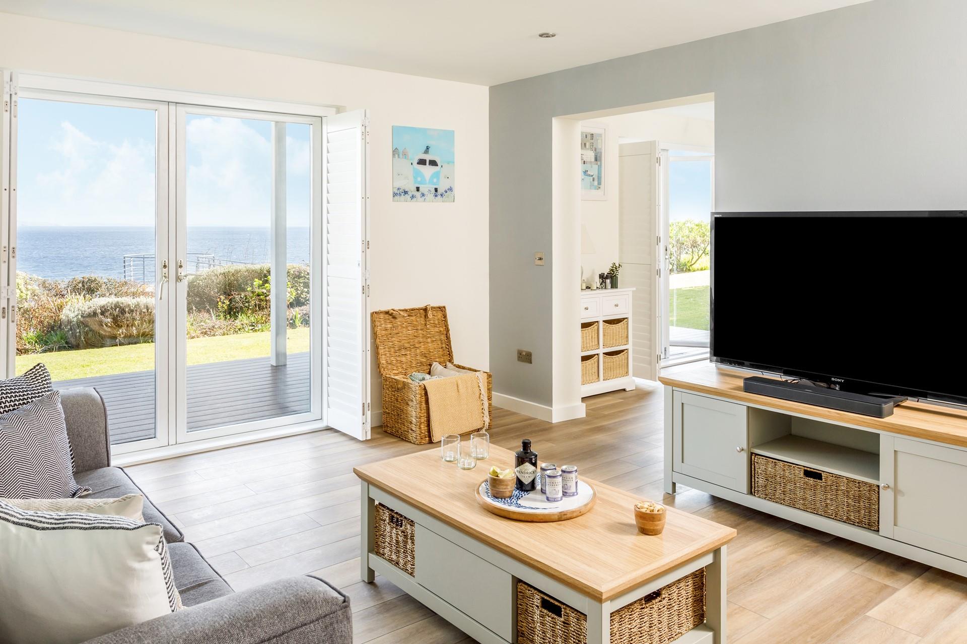 The sitting room has modern furnishings and a large TV perfect for movie nights.