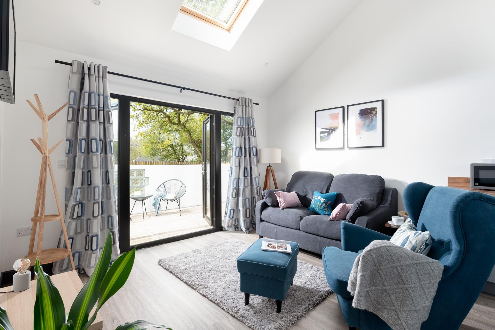 Sink into the sumptuous sofa soaking up the fresh summer breeze blowing through this couples retreat.