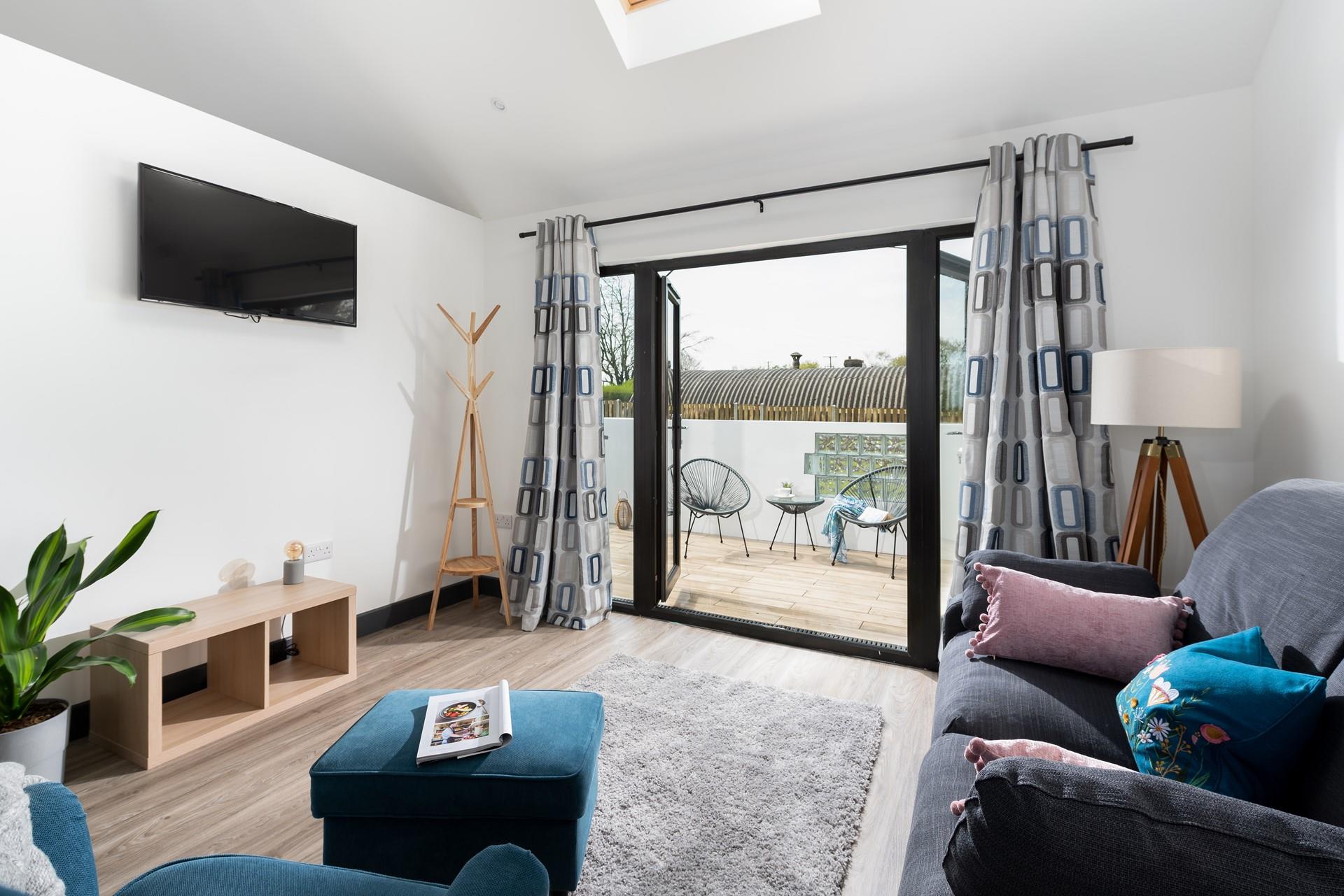 The sitting room is stylish and homely, the patio doors take advantage of the peaceful countryside location so you can enjoy the sights and sounds.