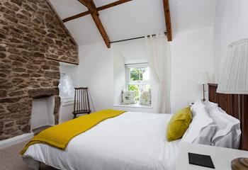 Traditional features like wooden beams and the granite feature wall create a cosy cottage feel.