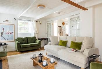 Pure relaxation awaits you at Lake Cottage with plush furnishings and rustic design features.