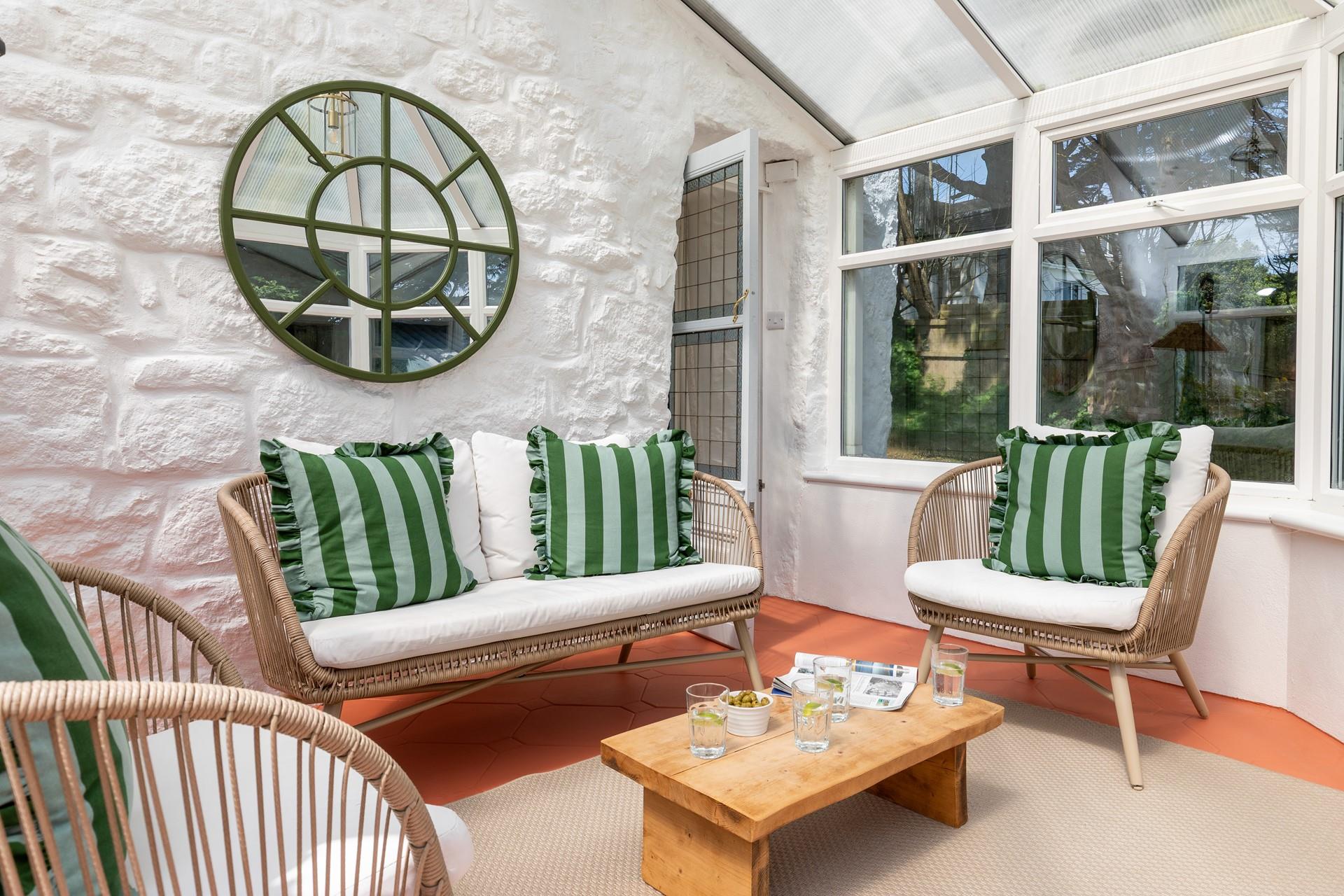 The sunny conservatory is a tranquil spot where you can listen to the sounds of bird song.