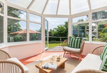 Patio doors take you out into the lush green garden!