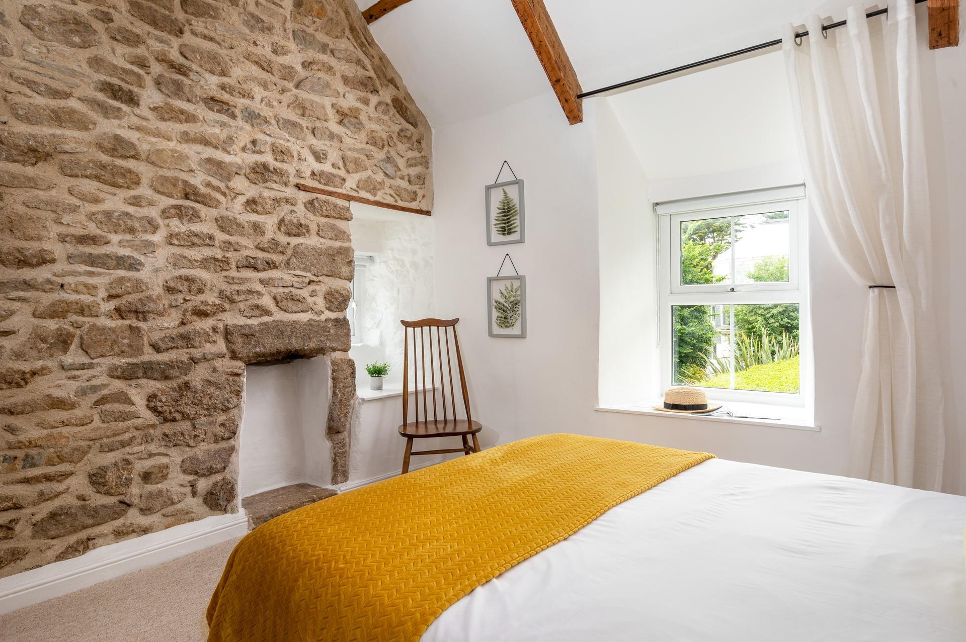 Traditional features like the feature wall create a cosy cottage feel.