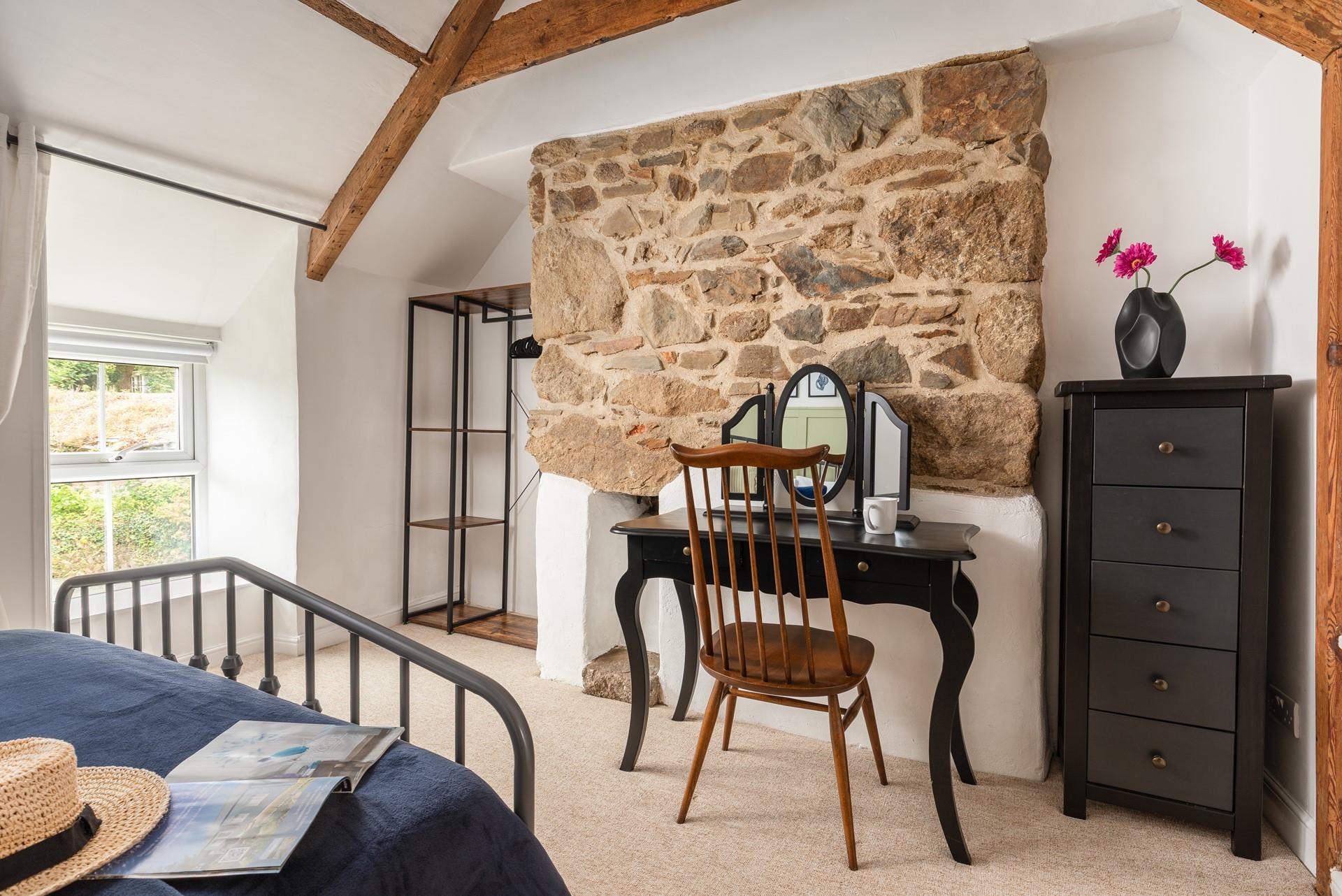 Decorated with calming blue and green tones, with classic cottage stonework.