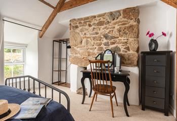 Decorated with calming blue and green tones, with classic cottage stonework.