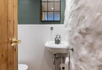 The downstairs cloakroom has a lovely combination of rustic features and stylish decor.