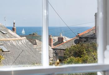 Peek through Mousehole's quirky rooftops to see the blue glisten of the sea.