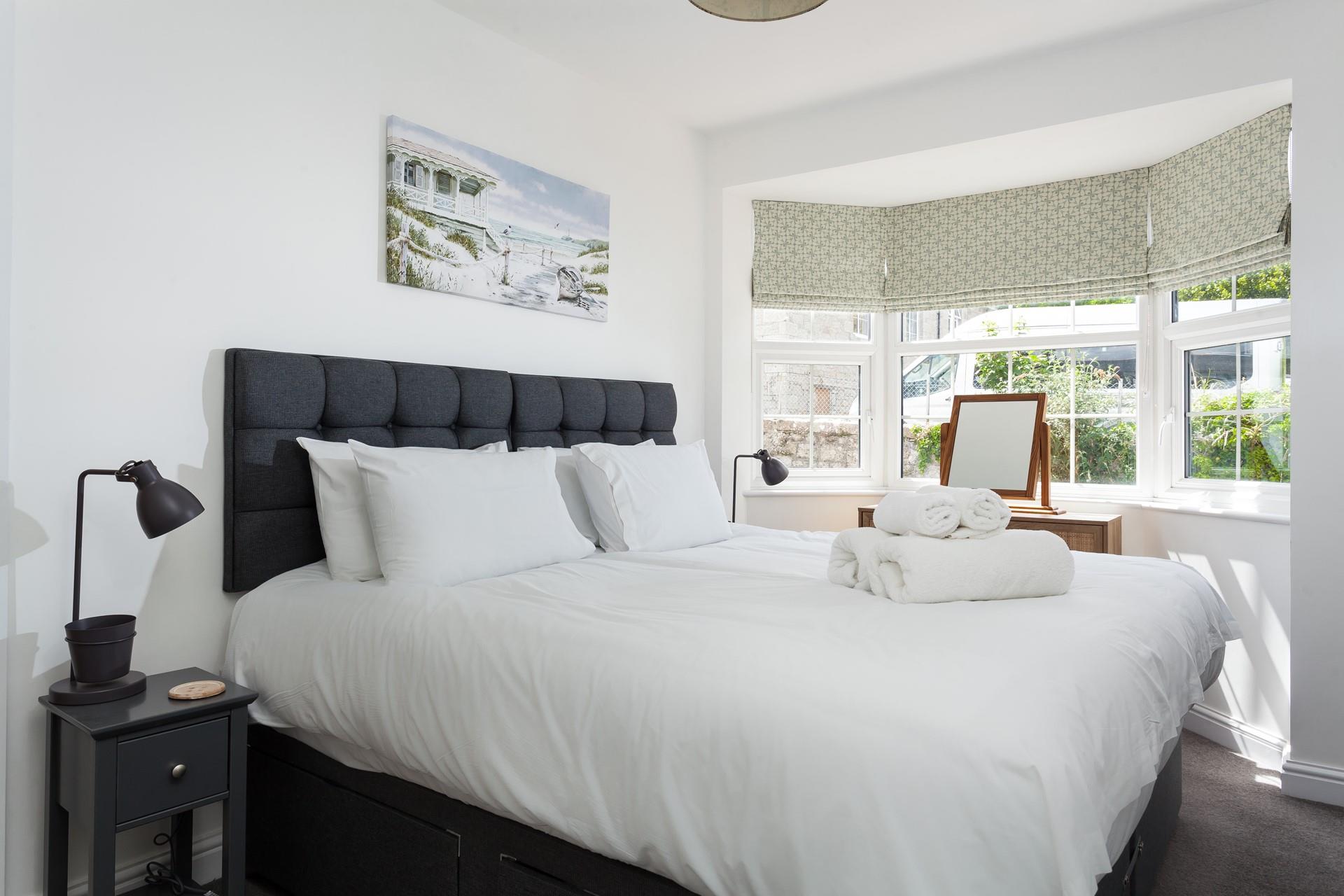 The spacious super king size bed provides you with a relaxing night's sleep.