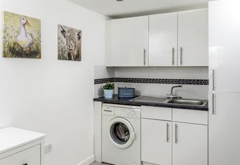 The utility room has a washing machine and handy storage for surfboards or bikes.