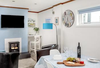 The kitchen/dining area has an additional space to unwind with an electric fire and TV.