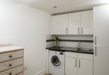 The utility room has a washing machine and handy storage for surfboards or bikes.
