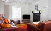 The bright sitting room provides a relaxing space in the evenings. - Thumbnail Image