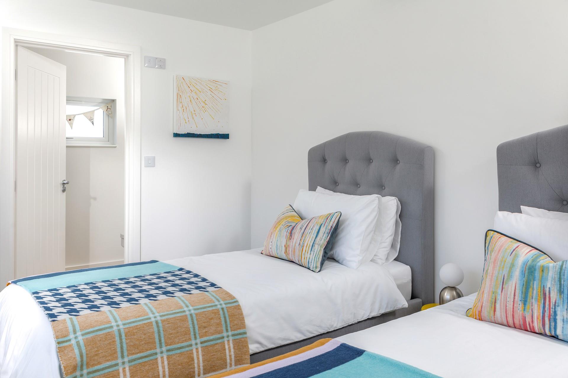 Bedroom 2 has twin beds perfect for kids or adults to snuggle into.