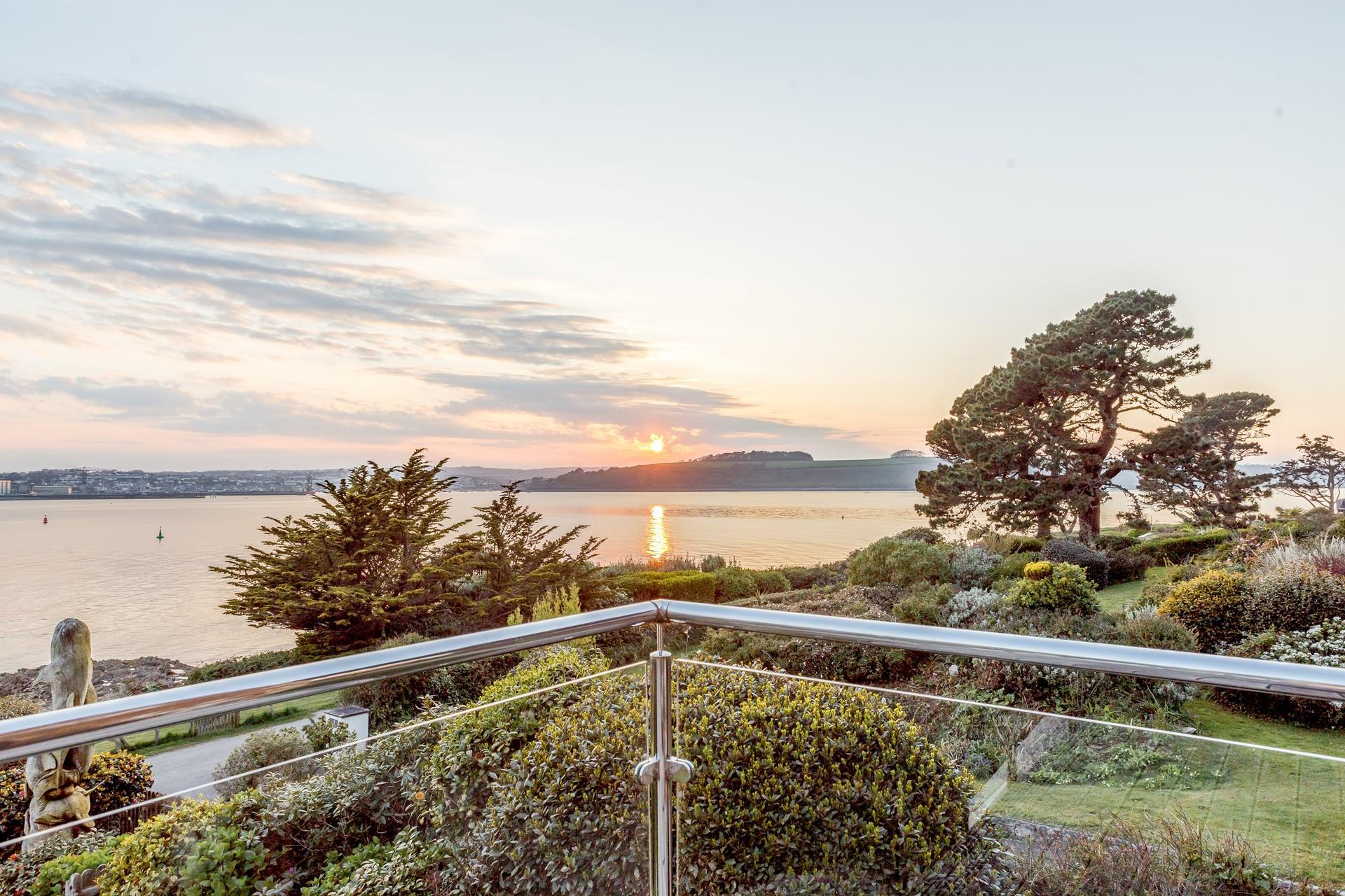 The balcony is the perfect spot to watch the sun set over the sea.
