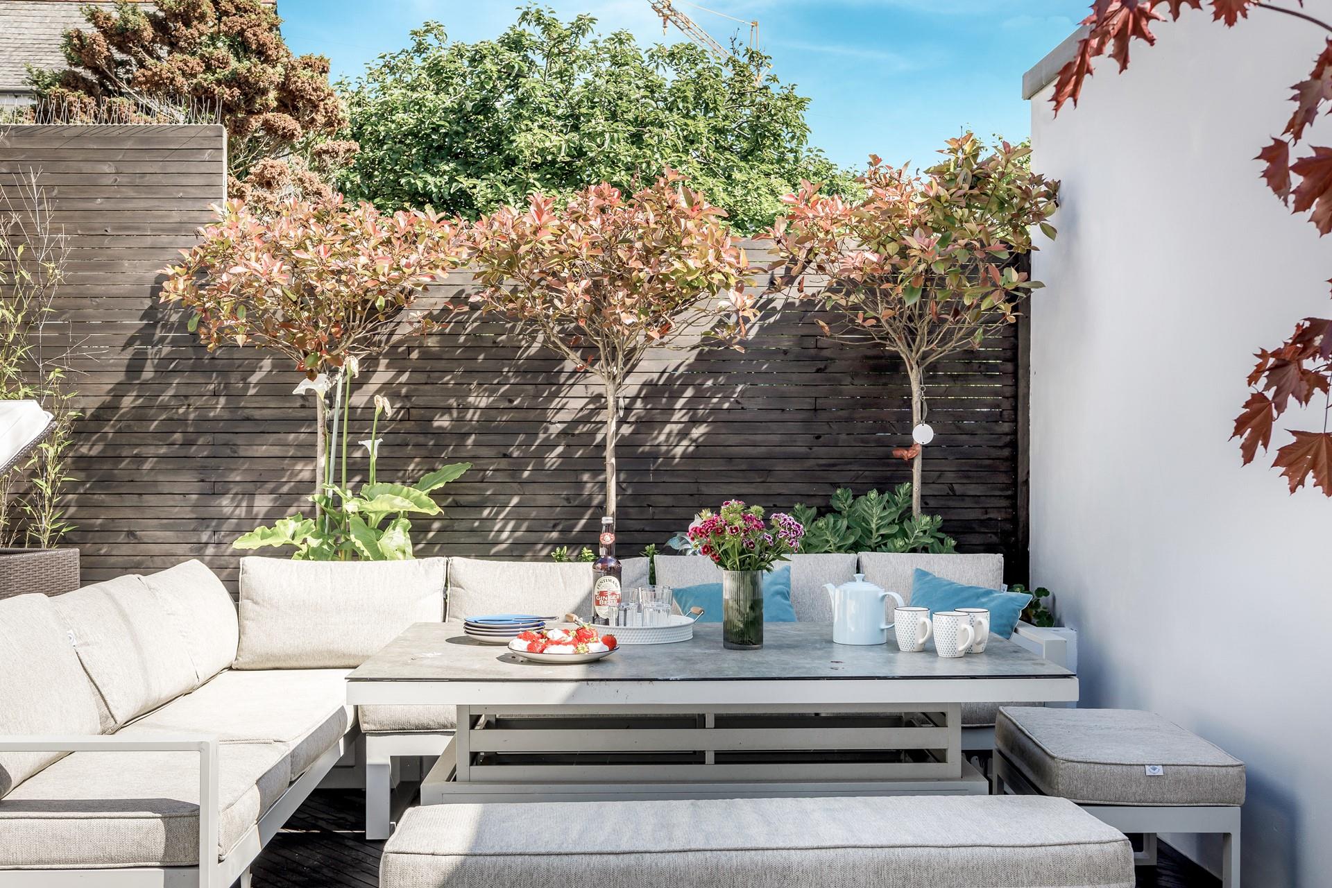 The sunken decked area has rattan furniture perfect for enjoying afternoon tea after spending the morning on the beach.