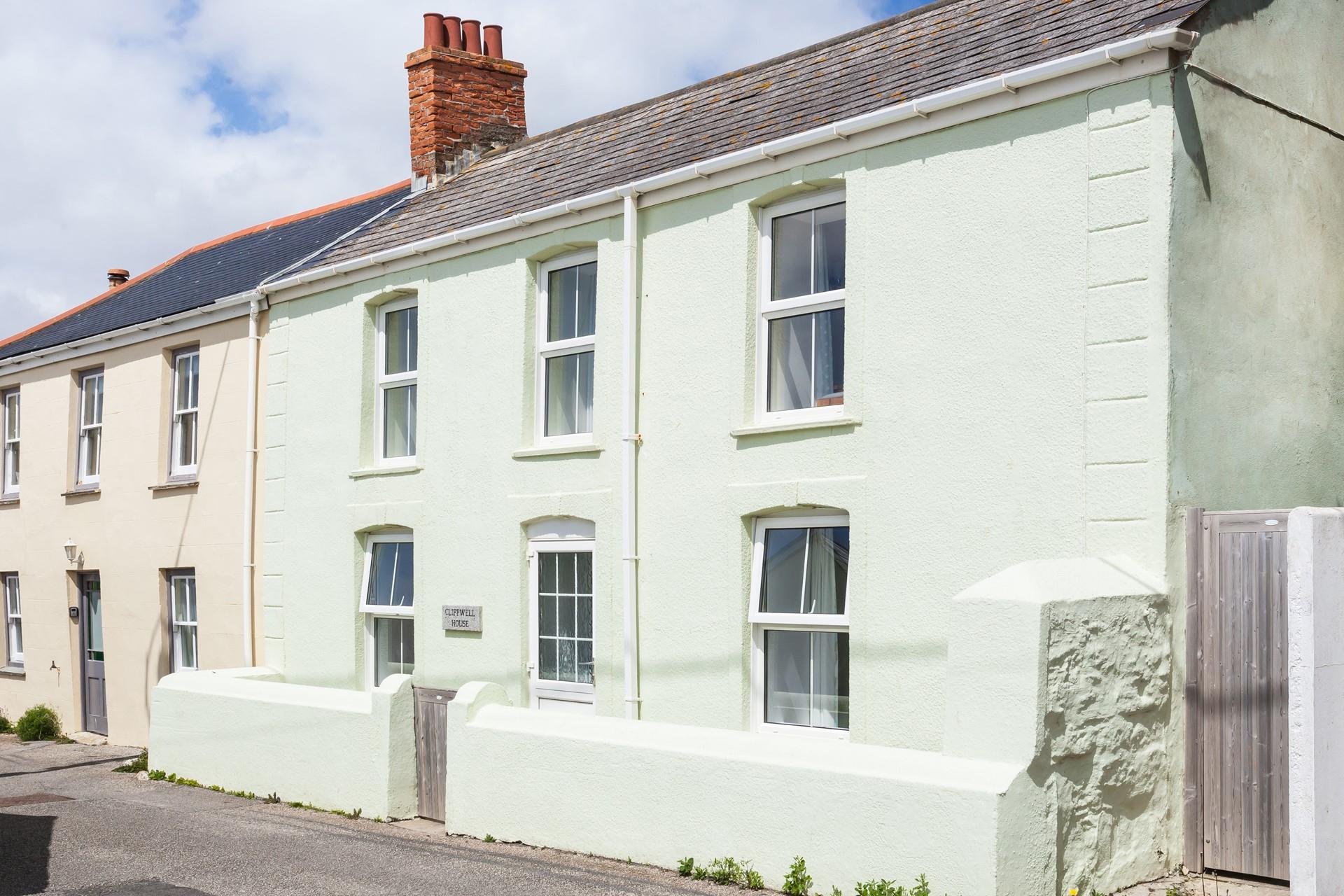 This Cornish seaside cottage is nestled behind the cliffs of Porthleven beach.