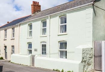This Cornish seaside cottage is nestled behind the cliffs of Porthleven beach.