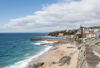 Watch the surfers ride the waves of Porthleven's famous surf break. 