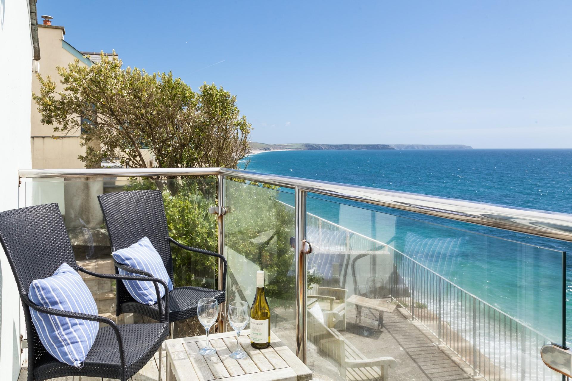 Watch the turquoise waves crashing on the sandy beach below. 