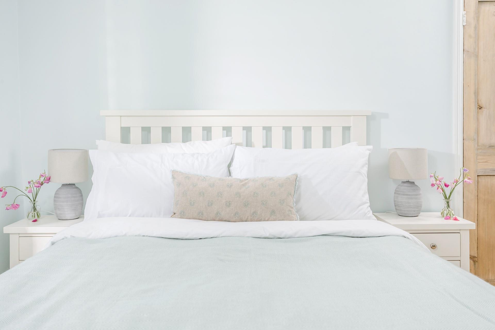 The bedrooms are decorated with calming pastel tones.