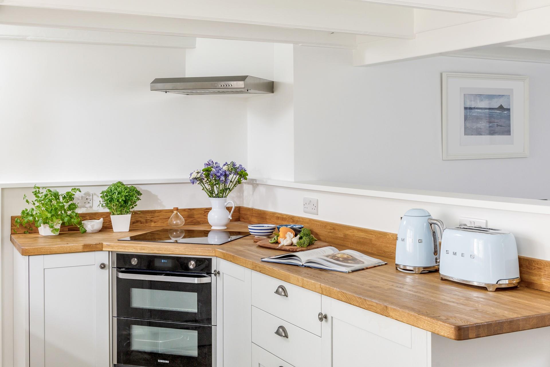 The kitchen is modern with all the appliances to prepare and cook tasty meals.