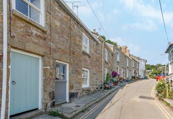 Charming Cornish cottages line the quaint streets.