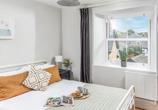 Bedroom 1 is furnished with a comfortable bed and has built-in storage for unpacking your suitcase.
