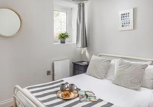 Bedroom 2 offers a cosy double bed, with open clothes rails for hanging up your holiday best.