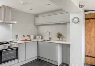 There is a compact cloakroom off of the kitchen which is a useful addition.