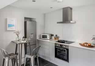A sleek, modern kitchen is ideal for cooking up a hearty breakfast in preparation for your day.