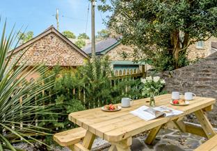 A small courtyard at the front of the house is just the spot for morning coffee or afternoon tea.