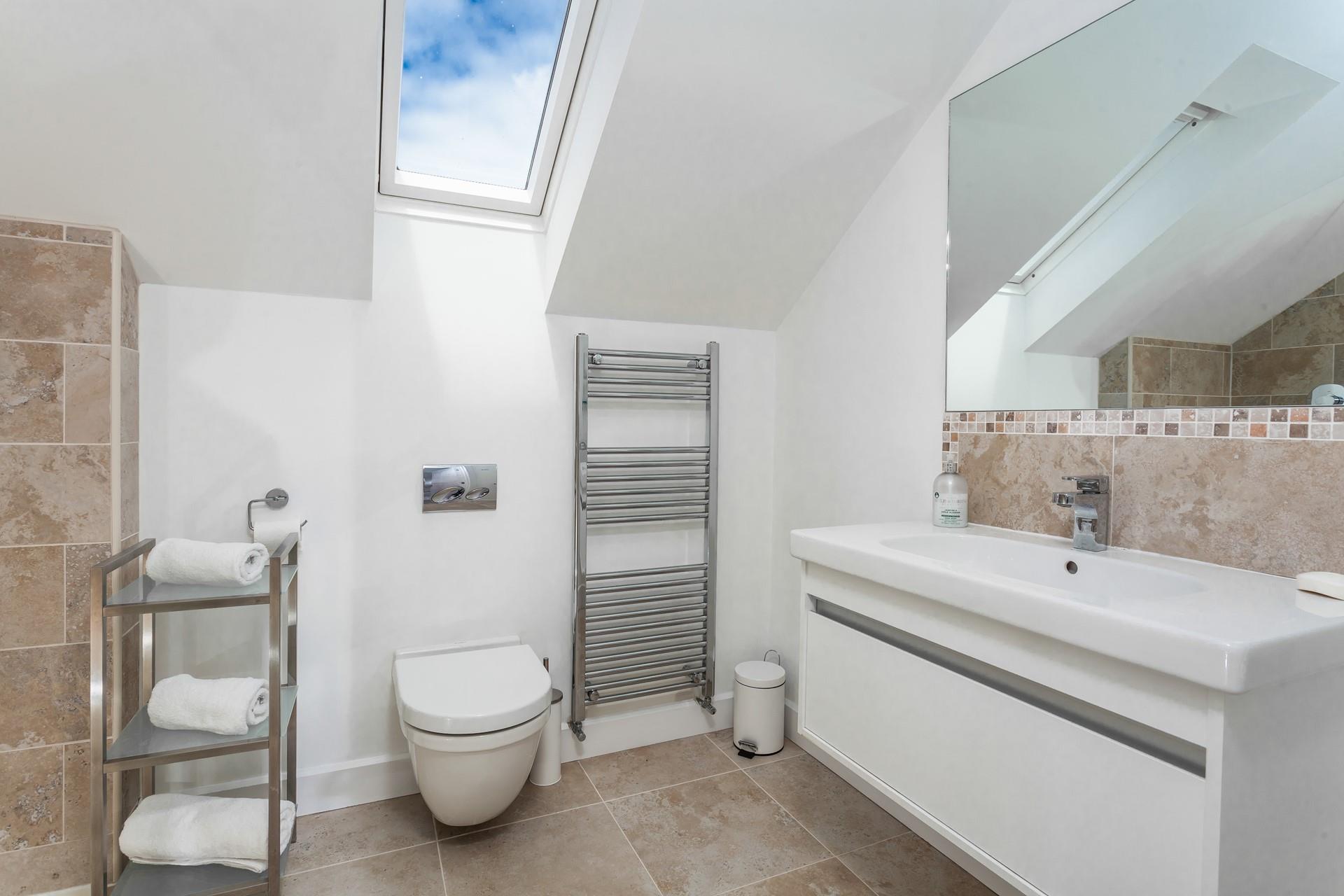 The en suite has a bath, shower and heated towel rail for warm fluffy towels in the morning.