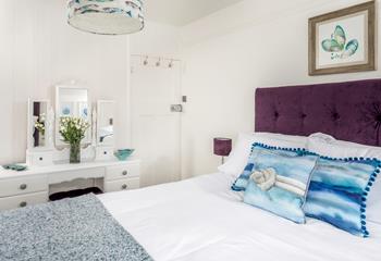 Bedroom 1 has a king size bed to tuck into and is decorated with an ocean theme.