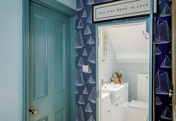 The upstairs shower room is beautifully finished with sleek tiles.