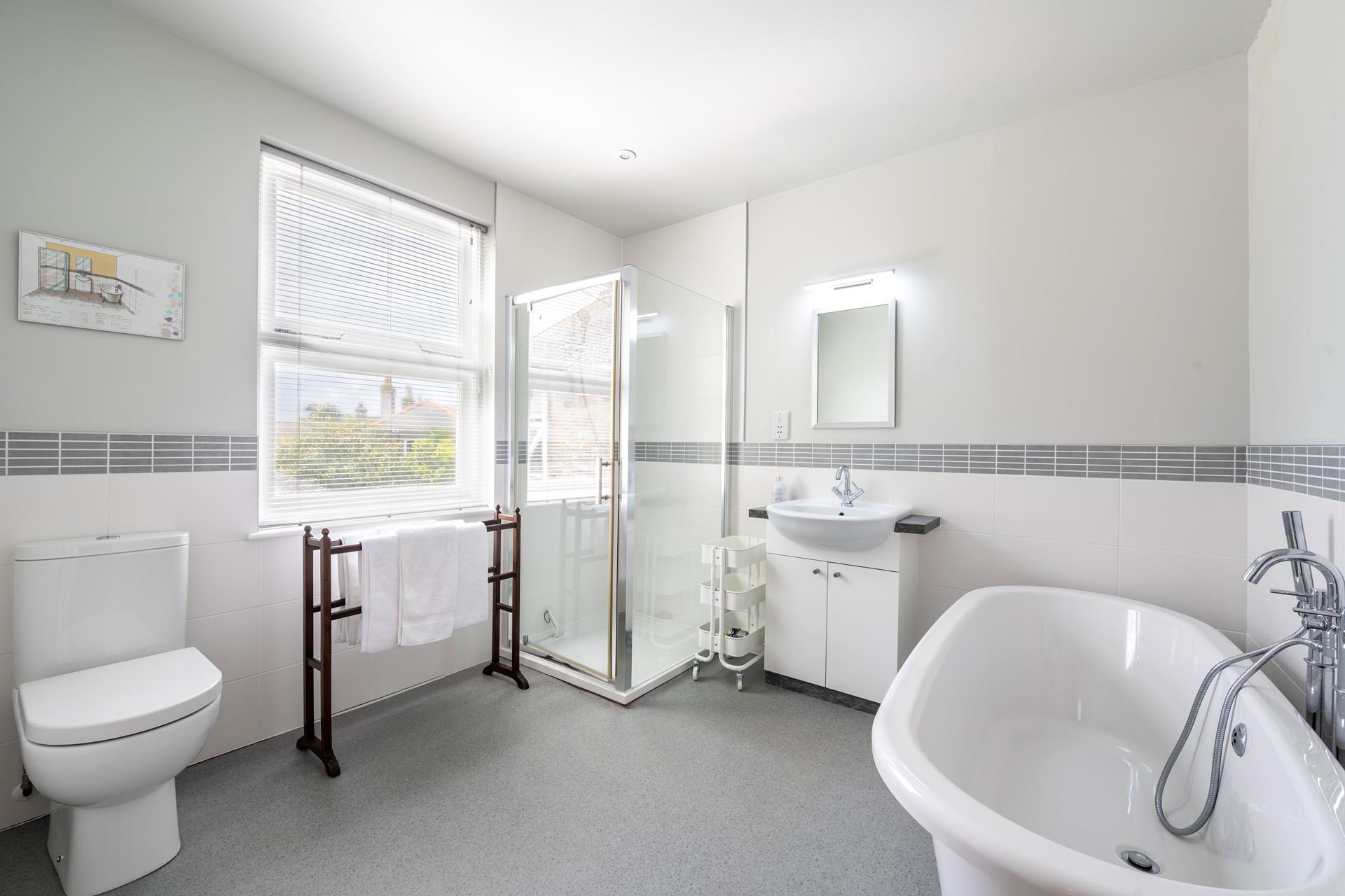 Choose between a bath or shower to start your day in the large bathroom.