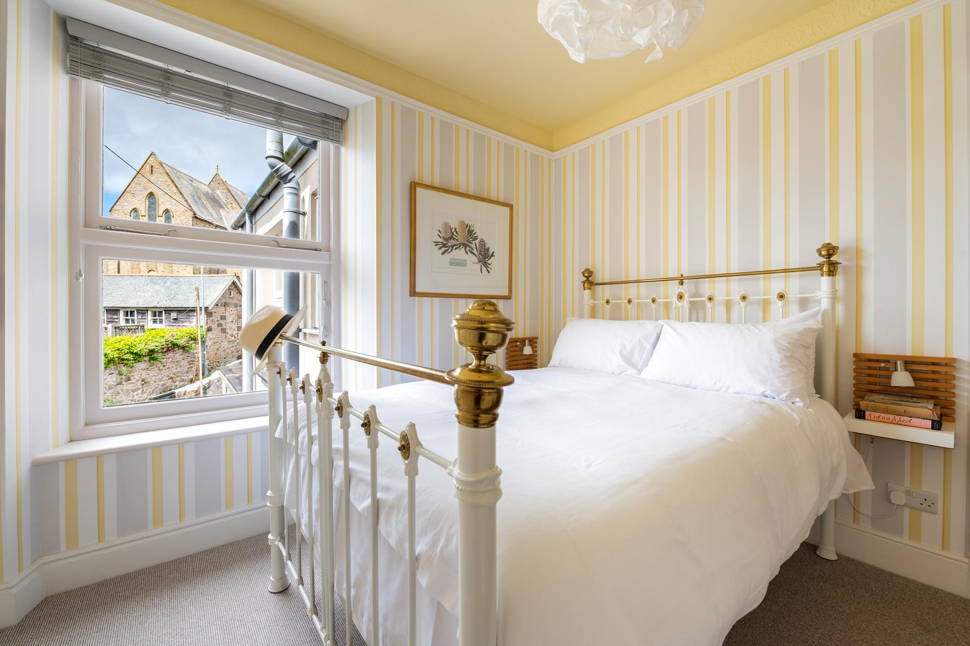 Bedroom 2 has views of the church and a comfy bed for a restful slumber.