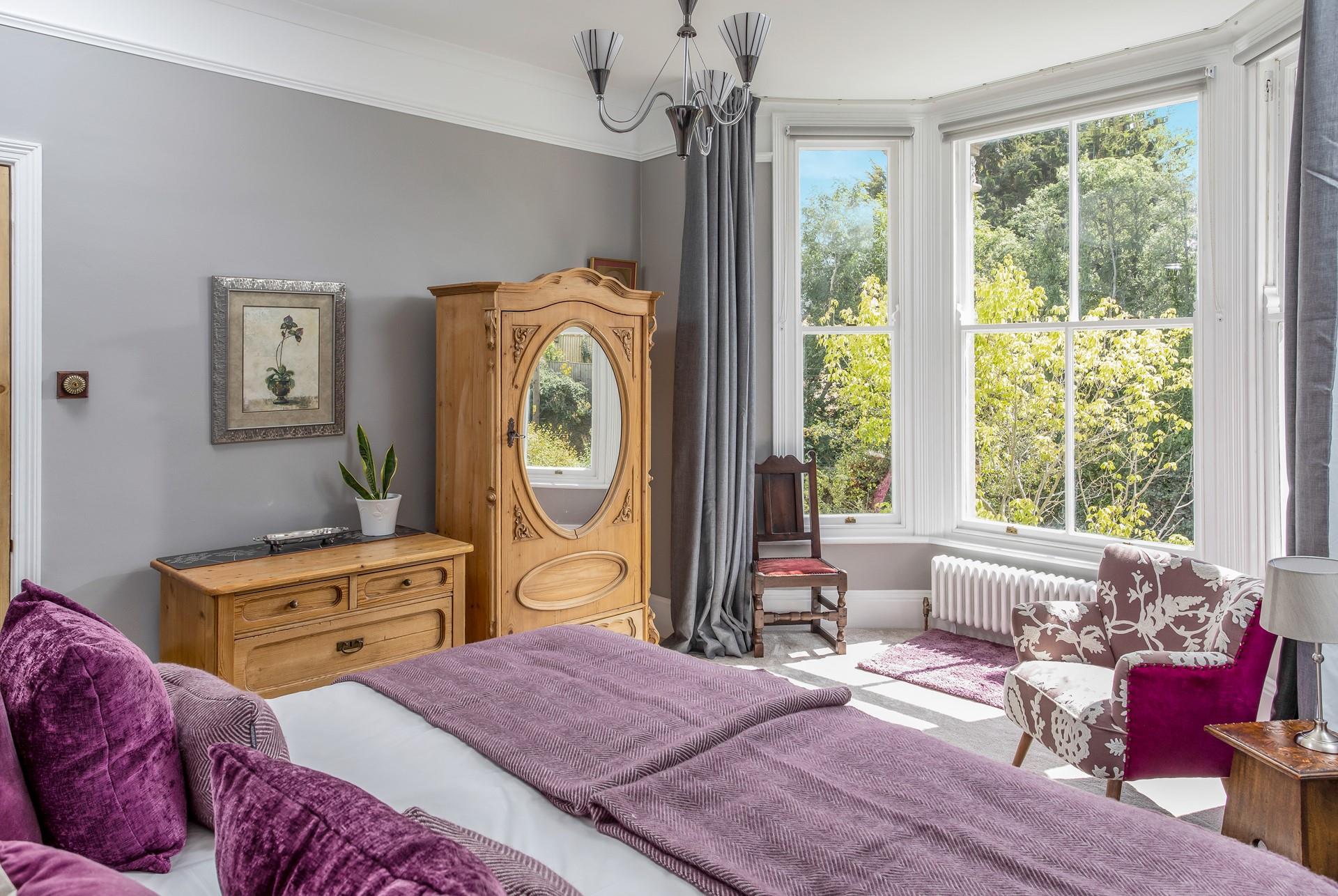 Open the curtains and let the sun shine through into the bedroom.