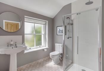 Start the day with an invigorating shower in the stylish bathroom.