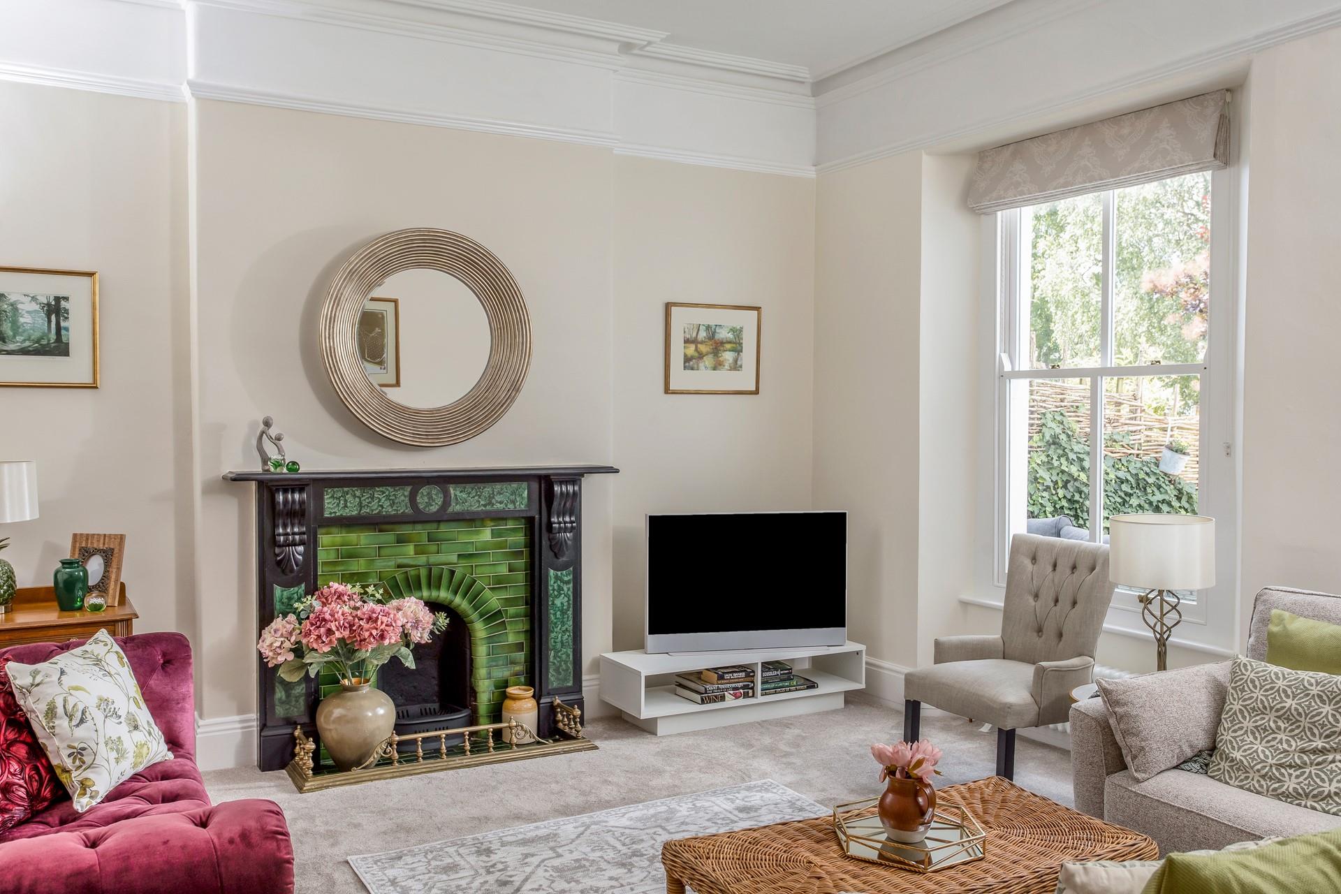 Full of light with a view of the garden, this opulent sitting room is a dream to relax in.