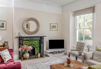 Full of light with a view of the garden, this opulent sitting room is a dream to relax in.