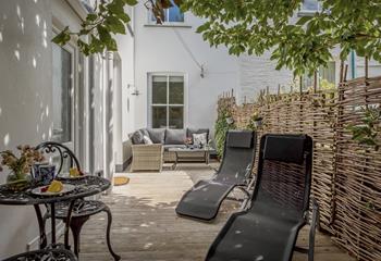 Relax in the sun loungers on the patio on a sunny afternoon after spending the morning exploring nearby Padstow.