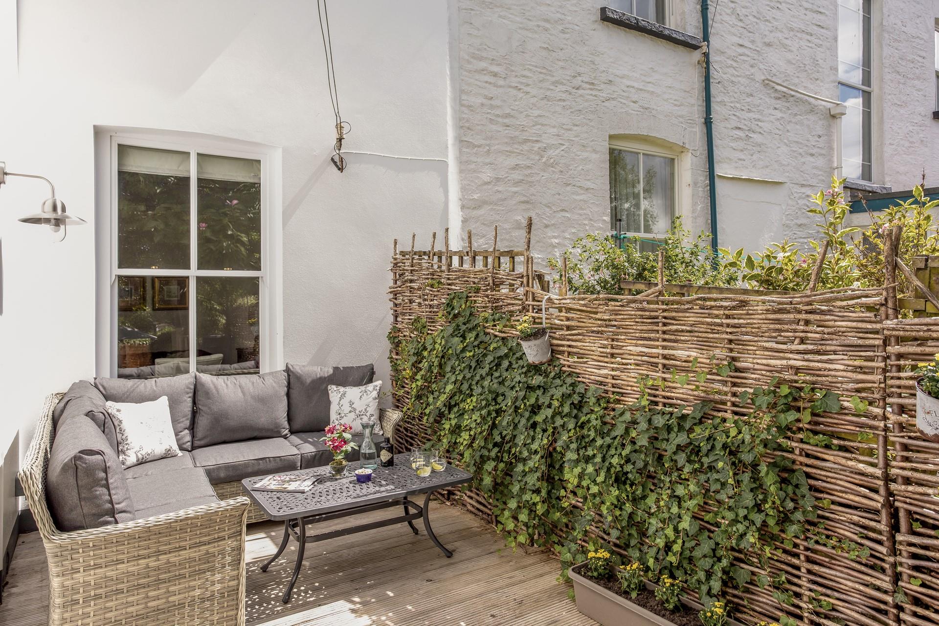 The garden features comfortable rattan furniture for al fresco nights.