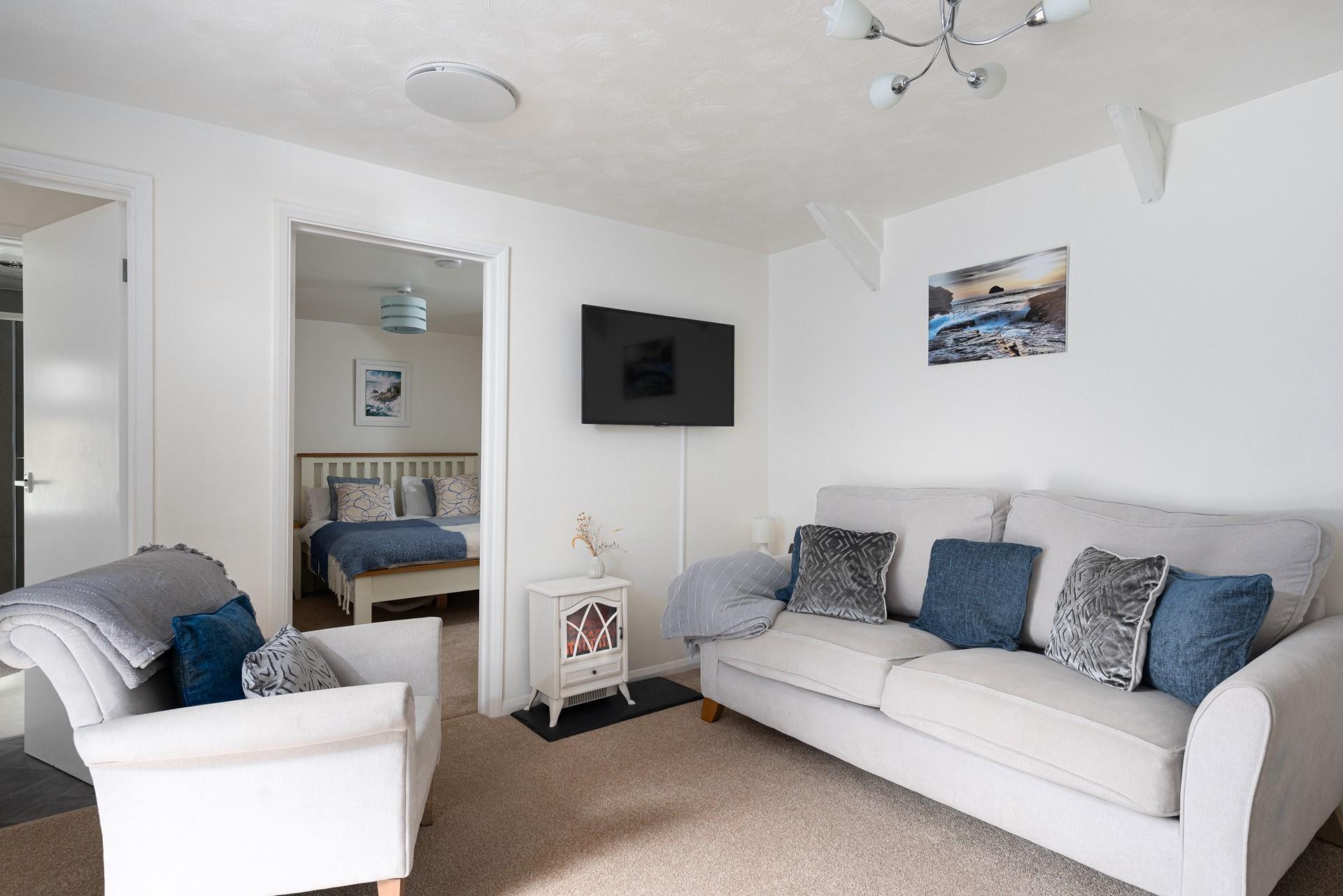 The cosy sofa provides a space to relax and put your feet up.