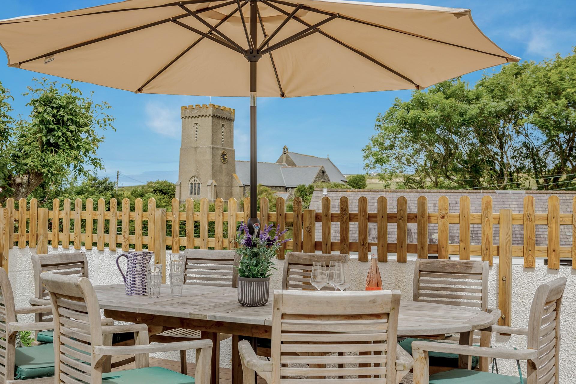 A beautiful garden table outside with a gorgeous view of the church.