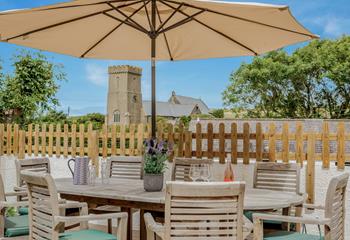 A beautiful garden table outside with a gorgeous view of the church.