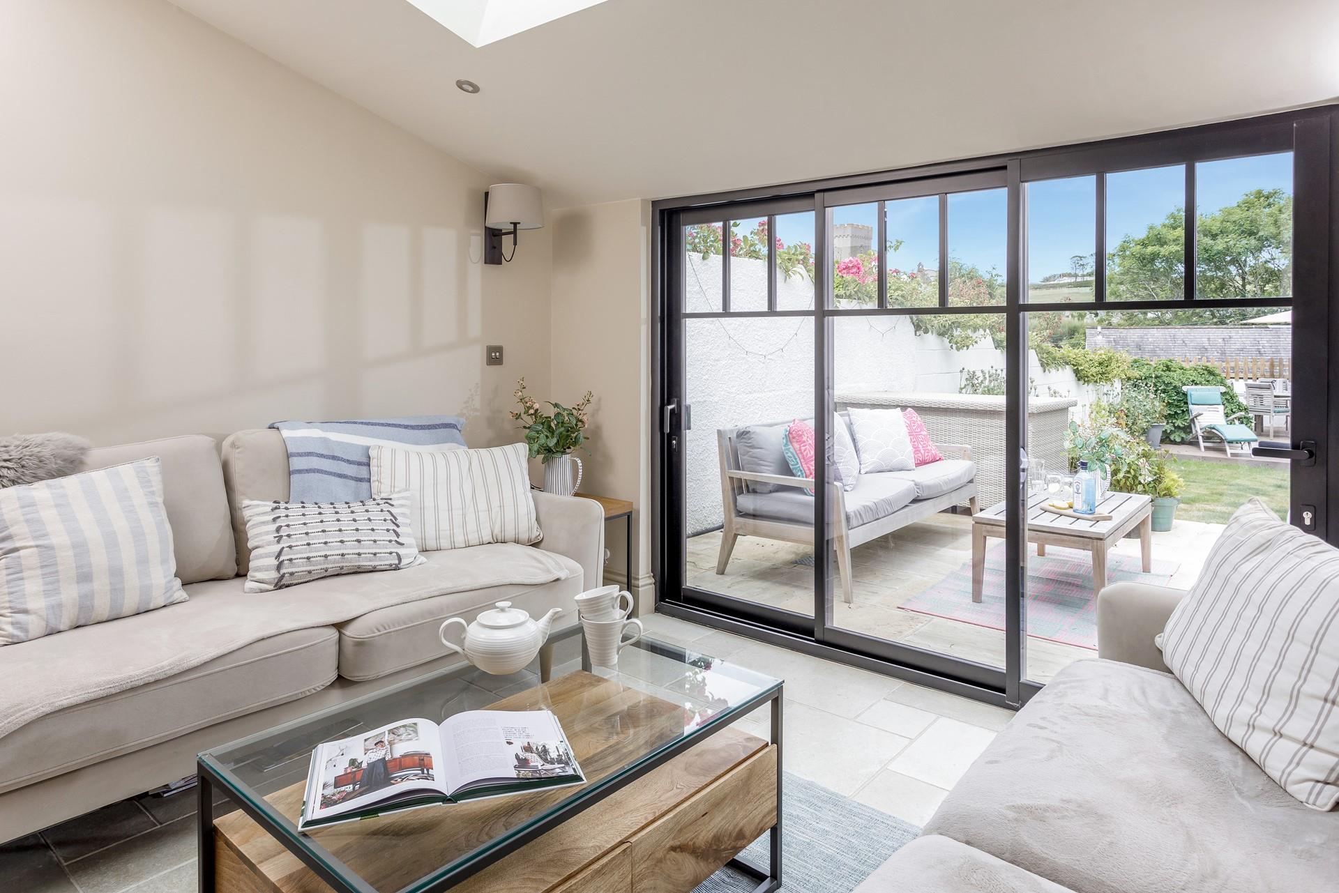 Step out onto the patio from the sunroom and breathe in the fresh Cornish sea air. 